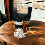 Package of Ceylon Natural Cardamom Flavored Tea in 24g and 25g sizes with cardamom and Ceylon tea leaves